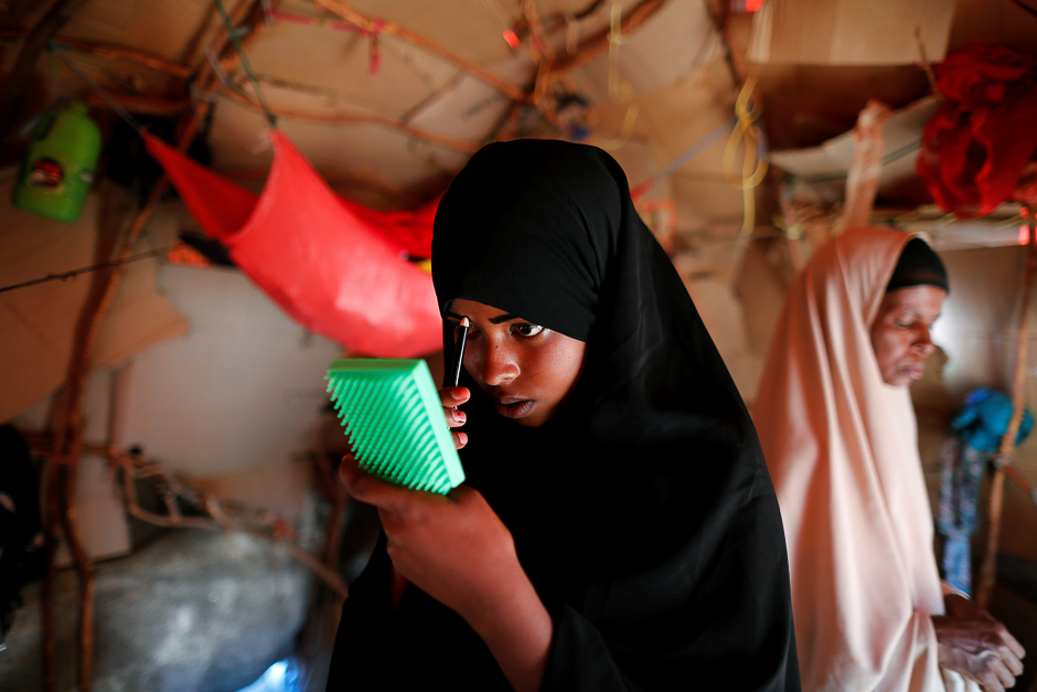Zeinab, 14, applies her make-up before heading to school inside her shelter at a camp for internally displaced people from drought hit areas in Dollow, Somalia. PHOTO: REUTERS