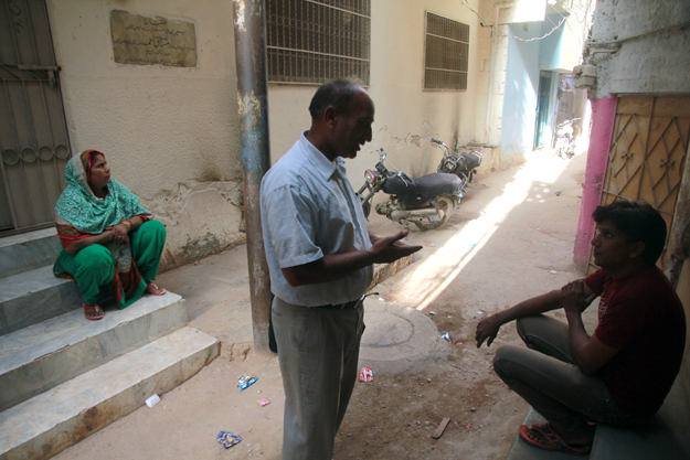 Pastor Masih visits around 100 families living in the city's large slums like Essa Nagri, Azam Basti, Natha Khan and Cattle Colony. PHOTO: ATHAR KHAN/EXPRESS