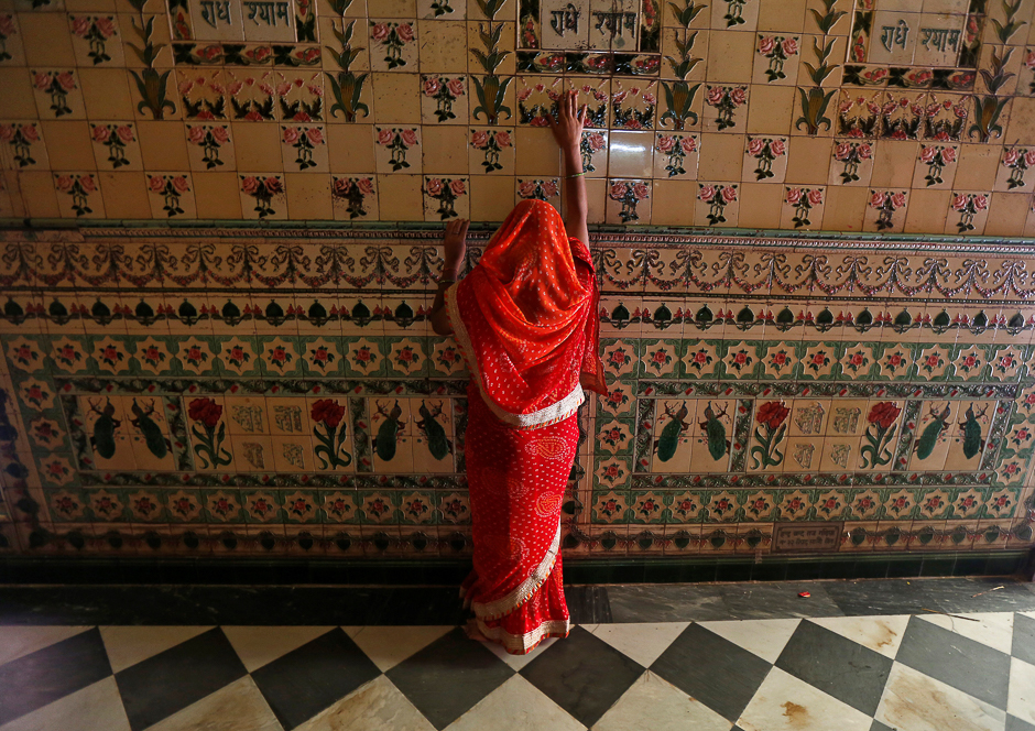 A woman prays as she touches the wall of a temple during Navratri festival in Kolkata, India. PHOTO: REUTERS