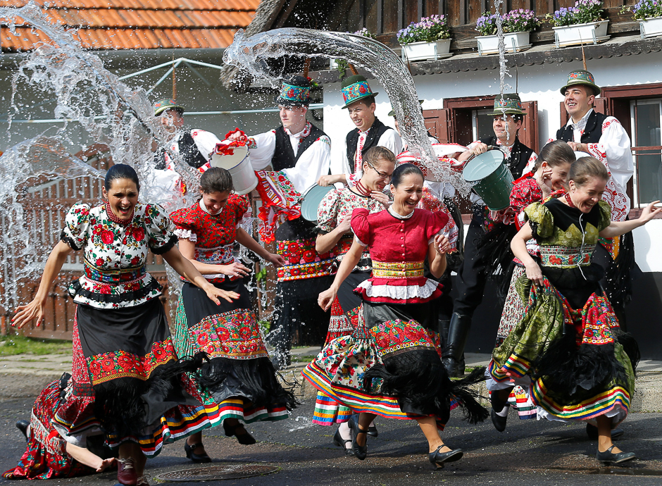 Girls dressed in traditional costumes run as men throw water on them as part of Easter celebrations during a presentation to the media in Mezokovesd, Hungary. PHOTO: REUTERS