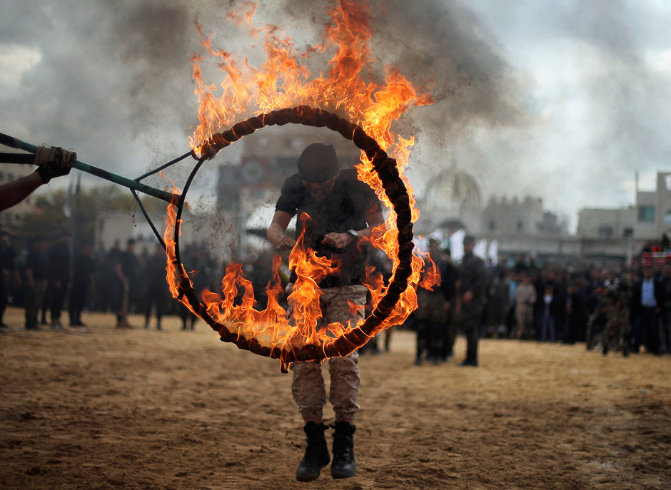 A Palestinian jumps through a ring of fire during a military exercise graduation ceremony organised by Palestinian national security forces loyal to Hamas, in Gaza City. PHOTO: REUTERS