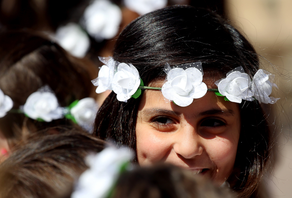 A Syriac Christian girl smiles during a service marking Easter Sunday at the Church of Saint Ephrem in the northeastern Syrian city of Qamishli. PHOTO: AFP