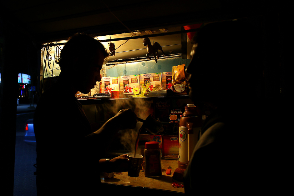 A Palestinian street vendor prepares coffee during a power cut in Gaza City. PHOTO: AFP