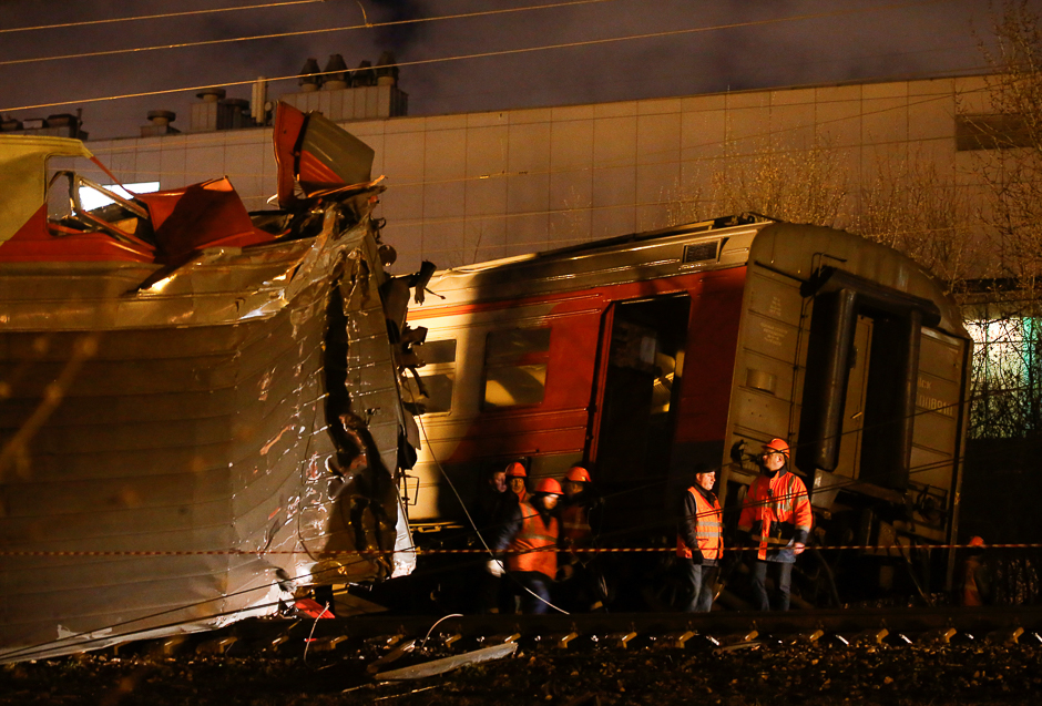 Emergencies Ministry members work at the site of a collision between a passenger train and a suburban train in Moscow, Russia. PHOTO: REUTERS