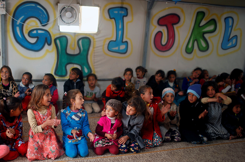 Displaced Iraqi children play inside a tent as they wait for the arrival of United Nations Secretary General Antonio Guterres during his visit at Hasansham camp, in Khazer, Iraq. PHOTO: REUTERS