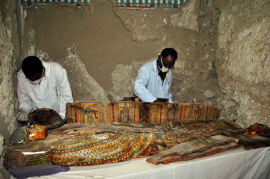 Members of an Egyptian archaeological team work on a wooden coffin discovered in a 3,500-year-old tomb in the Draa Abul Nagaa necropolis, near the southern Egyptian city of Luxor. PHOTO: AFP
