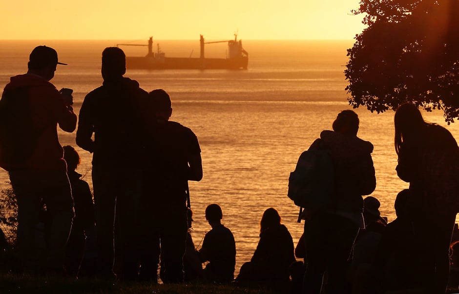 People look out towards the ocean on Cerro Castillo hill, after a mass evacuation of the entire coastline during a tsunami alert after a magnitude 7.1 earthquake hit off the coast in Vina del Mar, Chile. PHOTO: REUTERS