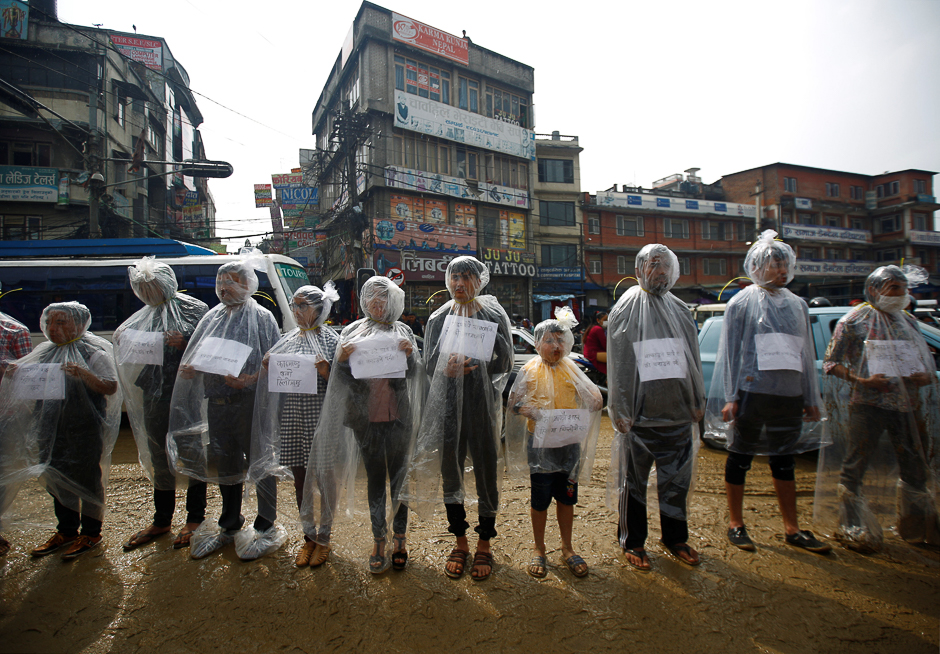 Activists take part in a demonstration to mark Earth Day by covering themselves in plastic sheets to protest against air pollution and muddy roads caused by what they say is a road expansion project in Kathmandu, Nepal. PHOTO: REUTERS