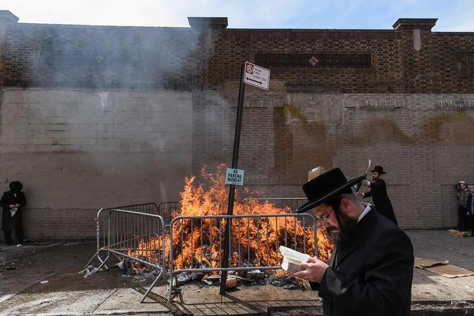 People participate in a Jewish religious ceremony called Srifes Chumetz involving a ritual burning of a bonfire before the start of Passover in the Brooklyn borough in New York, NY. PHOTO: REUTERS