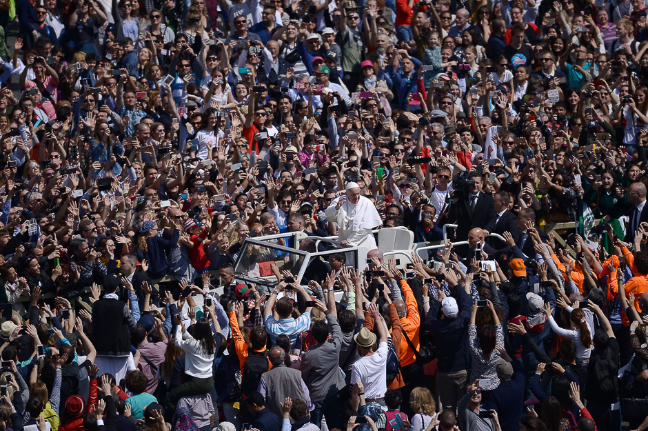 Pope Francis greets the crowd from the popemobile during the Easter Sunday mass at St Peter's square in Vatican. Christians around the world are marking the Holy Week, commemorating the crucifixion of Jesus Christ, leading up to his resurrection on Easter. PHOTO: AFP