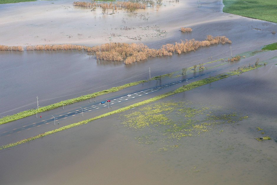 A supplied image shows three vehicles stranded on a highway flooded after Cyclone Debbie passed through the region near the township of Gunyarra, located south of the town of Bowen in Queensland, Australia. PHOTO: REUTERS