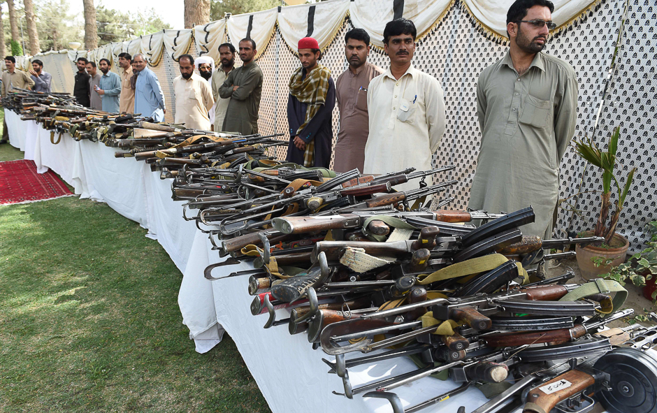 Pakistani security officials inspect weapons after they were handed over by Baloch militants when they surrendered to Pakistani security forces in Quetta. PHOTO: AFP