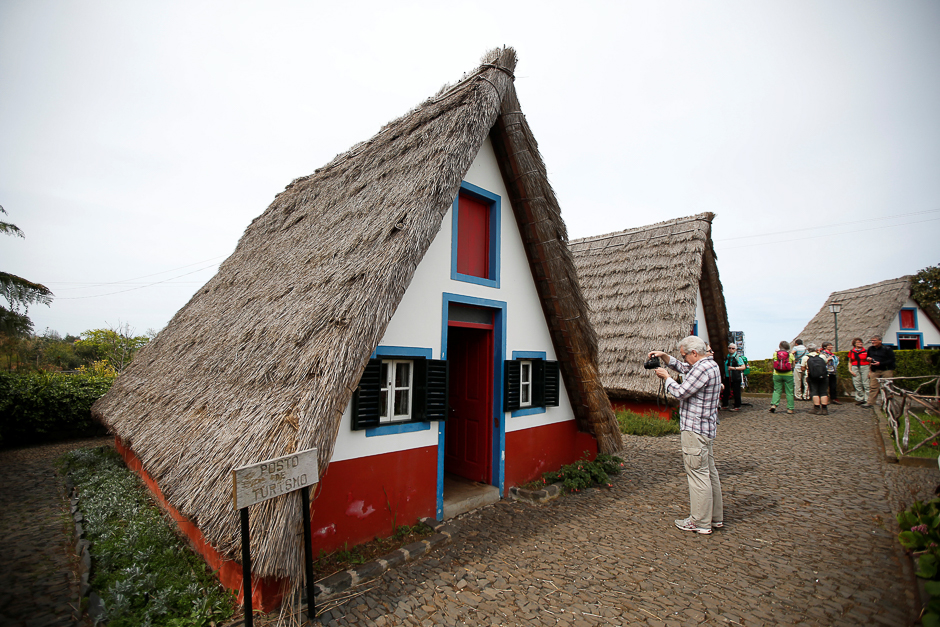 Tourists visit Madeira's traditional houses in Santana on Madeira's North coast, Portugal. PHOTO: REUTERS