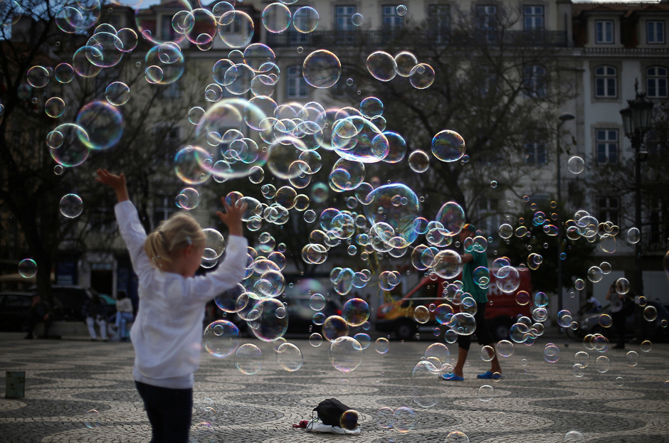 A street artist performs with soap bubbles at Rossio square in downtown Lisbon, Portugal. PHOTO: REUTERS