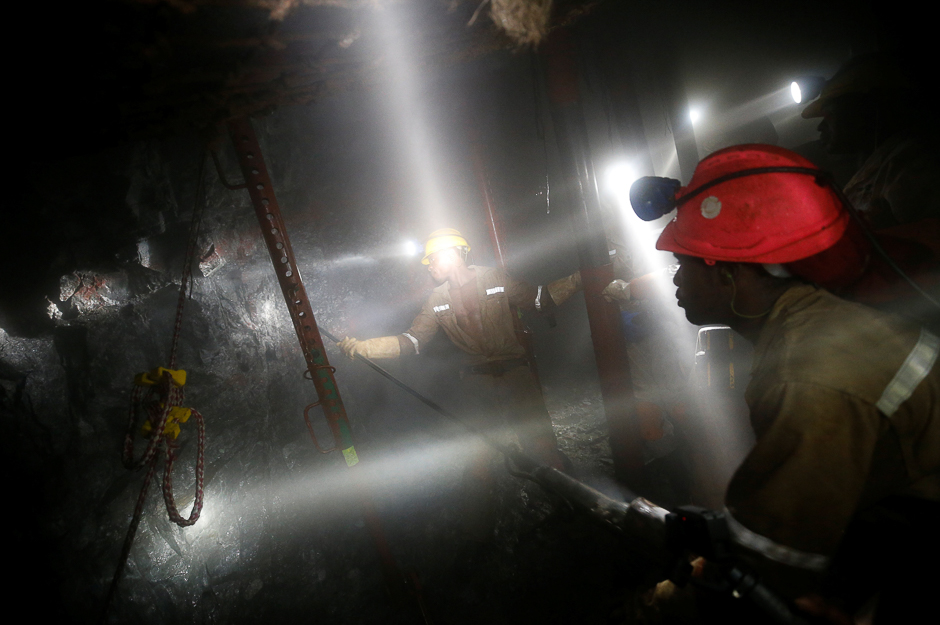 Mineworkers employed at Sibanye Gold's Masimthembe shaft operate a drill in Westonaria, South Africa. PHOTO: REUTERS