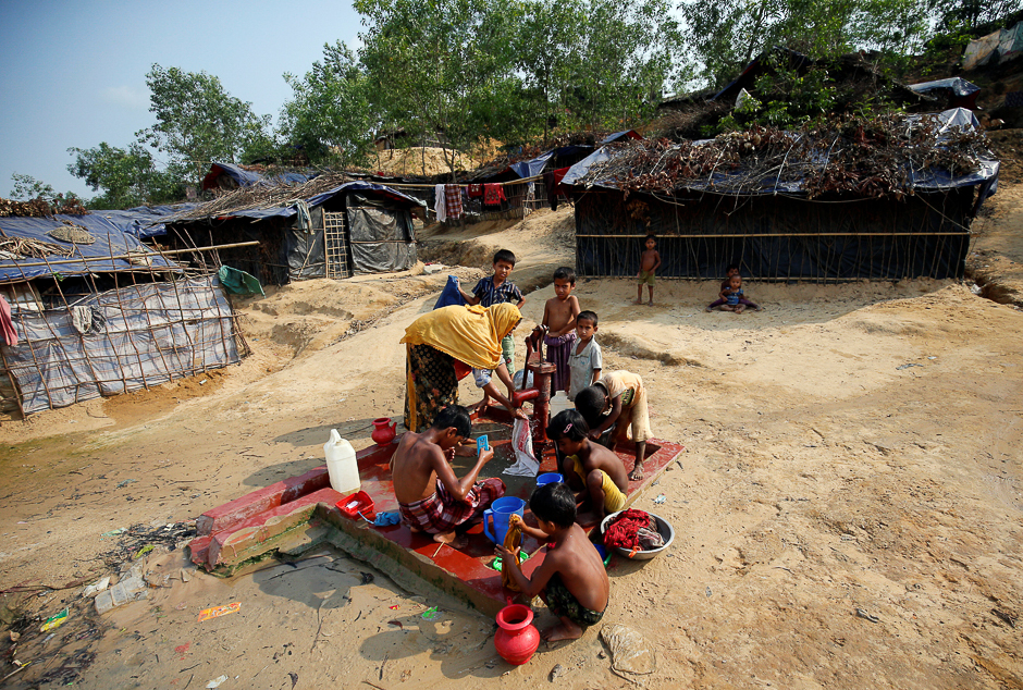 Rohingya refugees take bath and collect water from a tube-well at Balukhali Makeshift Refugee Camp in Cox's Bazar, Bangladesh. PHOTO: REUTERS