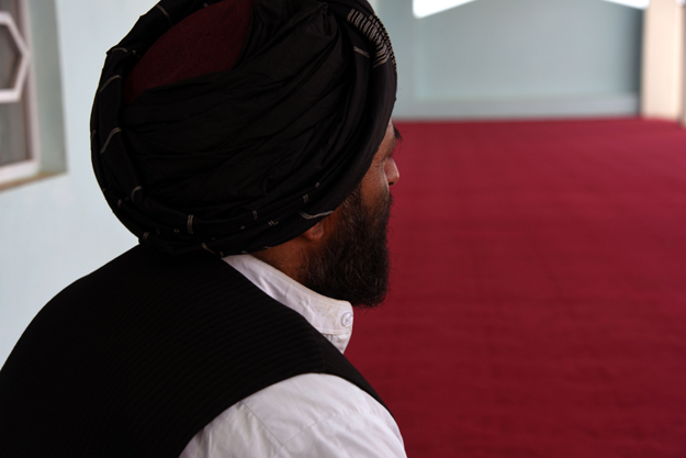 In this photograph taken on March 22, 2017, former Afghan Taliban commander Maulvi Abdul Rauf, 37, offers prayers inside a mosque in the Panjwayi district of Kandahar Province. An Afghan strongman is giving sanctuary to Taliban fighters and their families who have sought haven across the border in Pakistan, building on a radical strategy to reduce Islamabad's perceived influence on the insurgency. PHOTO: AFP
