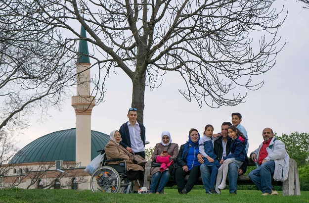 A family rests and sings near a mosque of the Islam Centre of Vienna on April 14, 2017 in Vienna, Austria. PHOTO: AFP