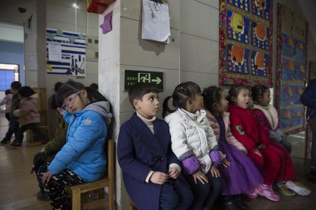 Alo-baidi Yousif [M], 4, an Iraqi child born in China, sits with other children in a kindergarten in Yiwu, Zhejiang Province, China 11 January 2017. PHOTO: Thomson Reuters Foundation