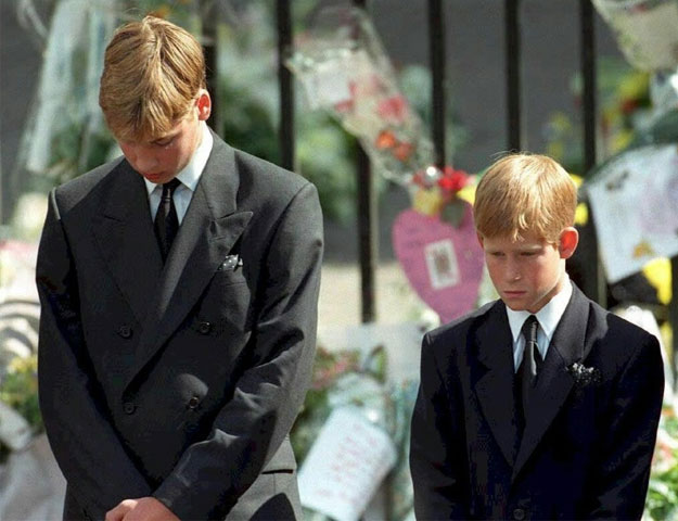 Prince William (left) and Prince Harry bow their heads during the funeral of their mother Diana, Princess of Wales, at Westminster Abbey in 1997 PHOTO: AFP