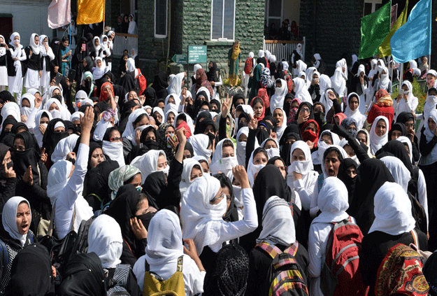 Kashmiri college students shout pro-freedom slogans during a protest inside a college in central Srinagar's Lal Chowk on April 17, 2017. PHOTO: AFP