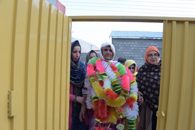 This photograph taken on February 12, 2017, shows Indian Kashmiri woman Ashraf Jan (C) being greeted by relatives at her son's house upon her arrival at a refugee camp on the outskirts of Muzaffarabad. PHOTO: AFP