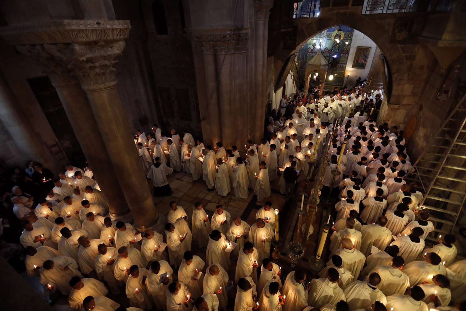 Latin Catholic clergymen hold candles as they circle the Anointing Stone during the Holy Thursday (Maundy Thursday) mass at the Church of the Holy Sepulchre in Jerusalem's Old City. PHOTO: REUTERS 