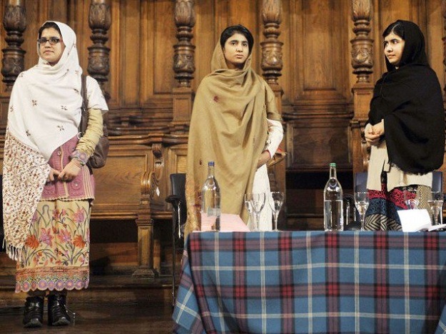 Three friends bonded by blood: Malala Yousafzai (R) stands next to her school friends Kainat Riaz (L) and Shazia Ramzan (C) during the first Global Citizenship Commission meeting at the University of Edinburgh in Scotland on October 19, 2013. PHOTO: AFP