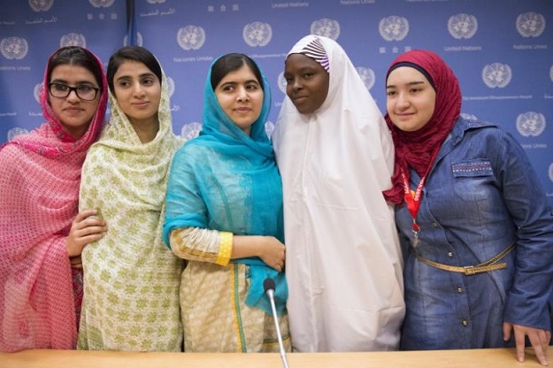 Nobel Peace Prize winner Malala Yousafzai (C) and her friends and fellow activists Kainat Riaz (L), Shazia Ramzan (2nd L), both from Pakistan, Amina Yusuf (2nd R) from Nigeria, and Salam Masri (R) from Syria, smile while at a news conference after speaking at the United Nations General Assembly at U.N. headquarters in New York, September 25, 2015. PHOTO: REUTERS