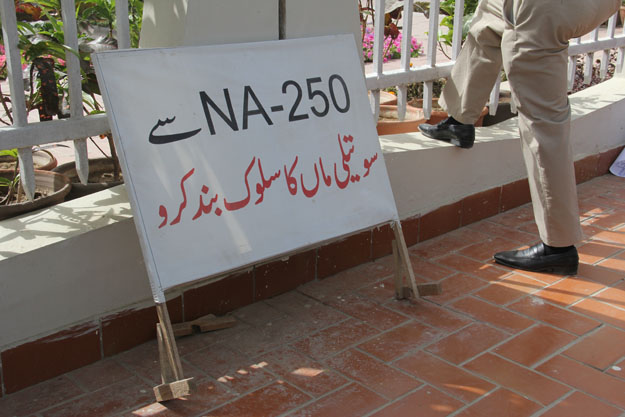 'Stop giving NA-250 step-motherly treatment' read a sign at the protest. PHOTO: AYESHA MIR/EXPRESS