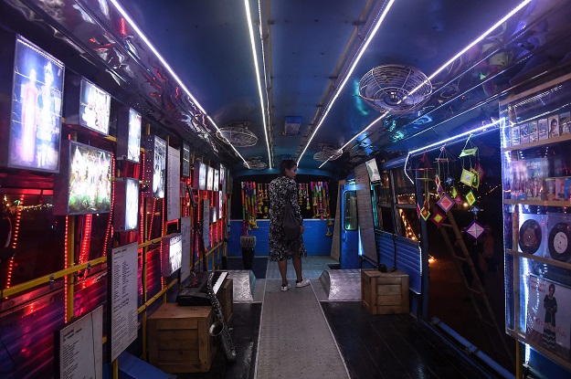This picture taken on February 17, 2017 shows a festivalgoer looking inside the Molam Bus at the Wonderfruit music festival in Chonburi. PHOTO: AFP