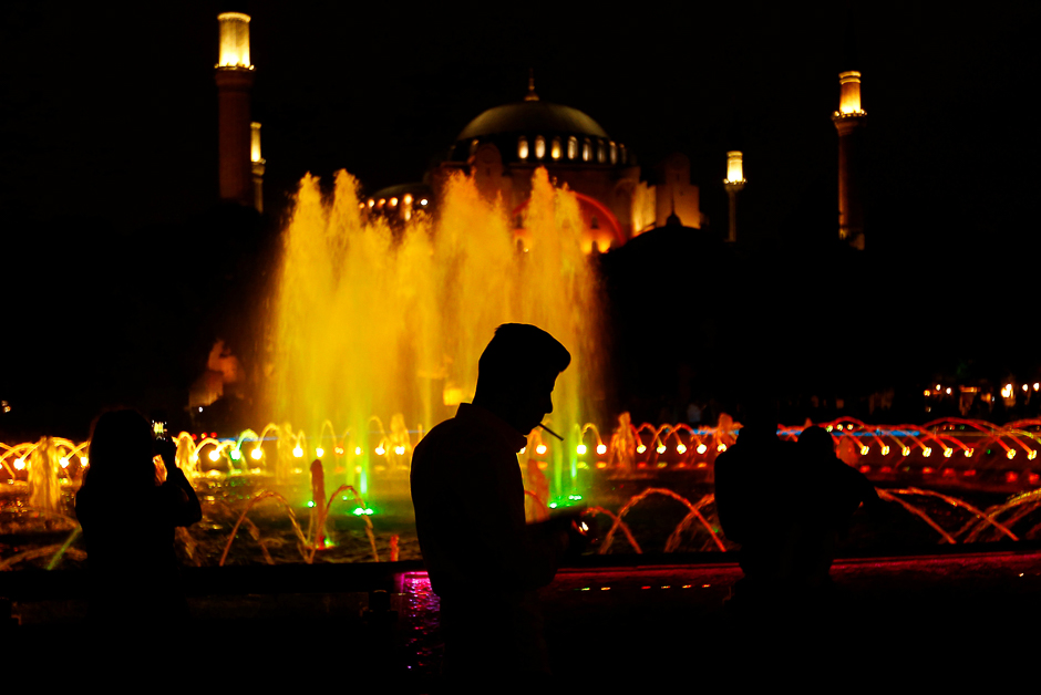 People stroll at Sultanahmet Square after iftar, the evening meal for breaking fast on the first day of the holy fasting month of Ramadan in Istanbul, Turkey. PHOTO: REUTERS