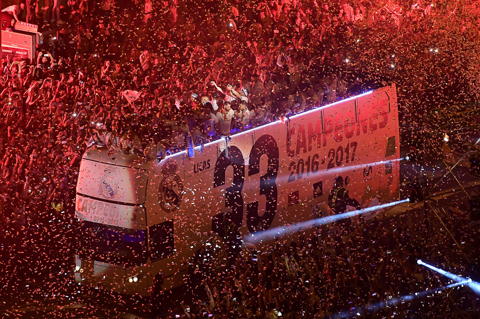 Real Madrid football team fans surround the bus as Real Madrid celebrate the team's win on Plaza Cibeles in Madrid after the Spanish league football match Malaga CF vs Real Madrid CF held at La Rosaleda stadium in Malaga. PHOTO: AFP
