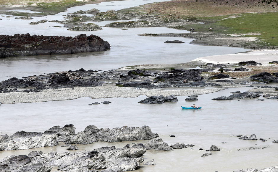 A man rows his boat on the waters of the Indus River in Attock, Pakistan. PHOTO: REUTERS