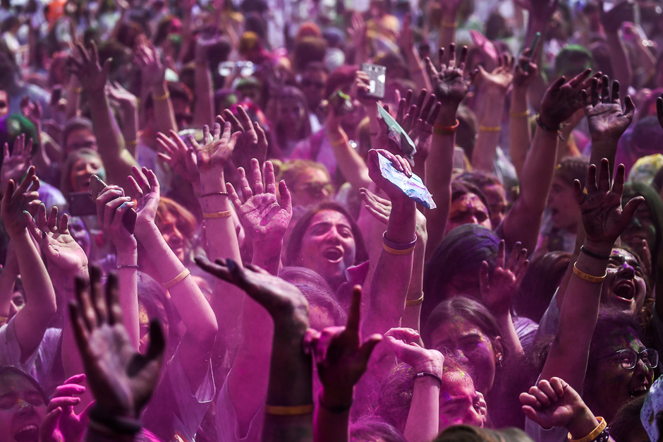 People gesture and dance as they take part in the Colour Festival. PHOTO: AFP