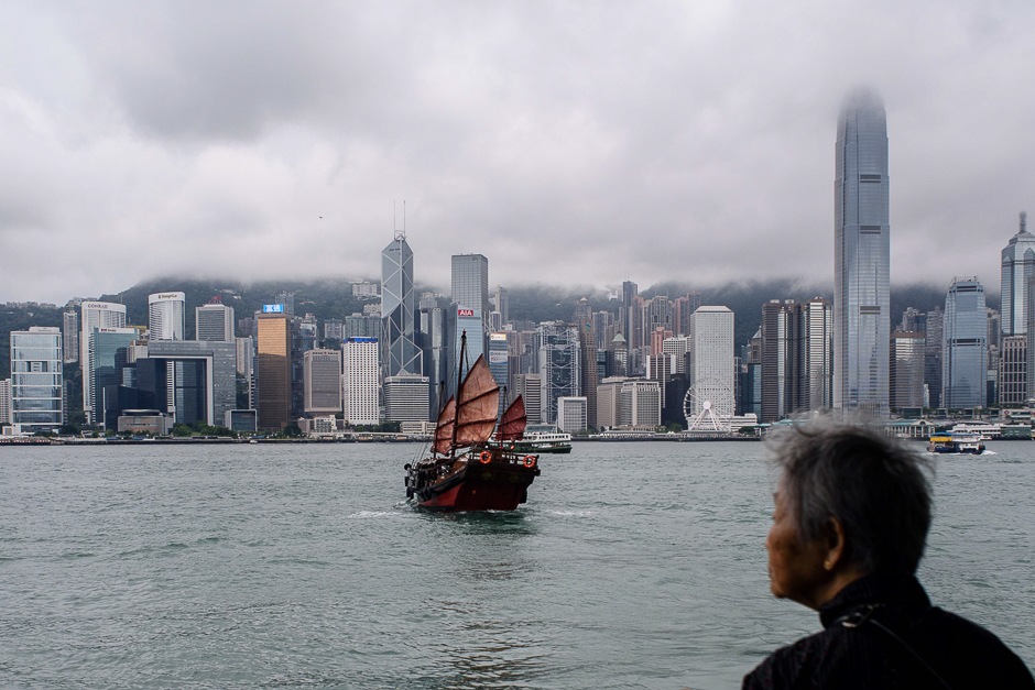 An elderly lady watches as a traditional junk sails in Victoria Harbour in Hong Kong. PHOTO: AFP