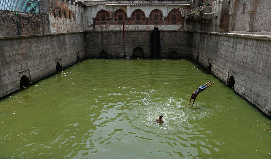 An Indian child dives into the waters of a baoli or a step-well at Nizamuddin Dargah in New Delhi. PHOTO: AFP