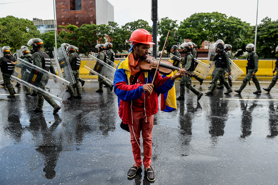 An opposition demonstrator plays the violin during a protest against President Nicolas Maduro in Caracas. PHOTO: AFP
