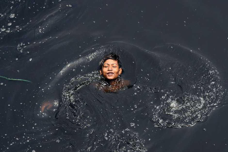 An Indian youth swims in the polluted Yamuna river amid rising temperatures in New Delhi. PHOTO: AFP