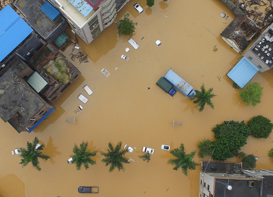 This shows vehicles in a flooded street in Zengcheng District, Guangzhou, in China's southern Guangdong province. Parts of the district were flooded between one and three metres deep, with authorities sending boats to provide stranded residents with food and water. PHOTO: AFP