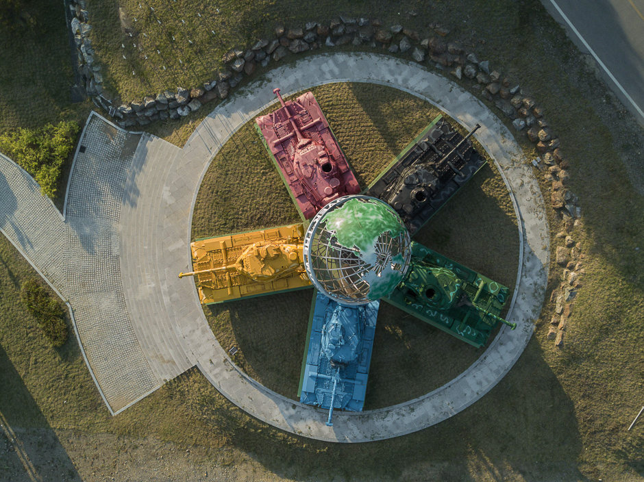 An aerial view of an art installation featuring Korean war-era tanks painted in different colours around a globe with a slogan reading: 'Peace All Around the World', at the Peace dam, north of Hwacheon near the Demilitarised Zone (DMZ) separating North and South Korea. PHOTO: AFP
