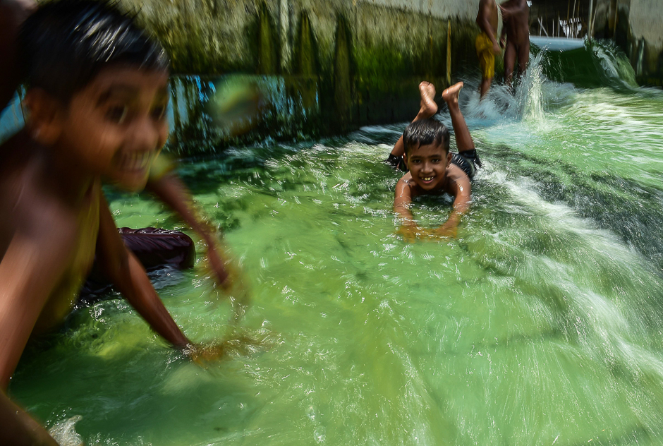 Bangladeshi youths play in a pool amid rising temperatures in Dhaka. PHOTO: AFP