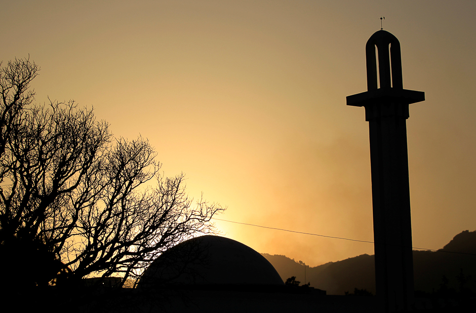 The sun sets behind a mosque ahead of Ramadan in Islamabad. PHOTO: REUTERS
