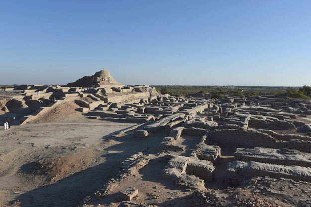 In this photograph taken on February 9, 2017, visitors walk through the UNESCO World Heritage archeological site of Mohenjo Daro some 425 kms north of the Pakistani city of Karachi. Once the centre of a powerful civilisation, Mohenjo Daro was one of the world's earliest cities -- a Bronze Age metropolis boasting flush toilets and a water and waste system to rival modern standards. Some 5,000 years on archaeologists believe the ruins could unlock the secrets of the Indus Valley people, who flourished around 3,000 BC in what is now India and Pakistan before mysteriously disappearing. PHOTO: AFP