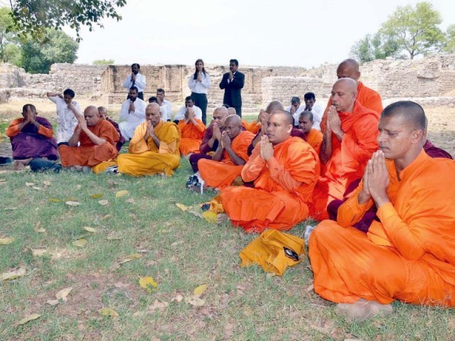Buddhist monks visit their holy sites at Taxila