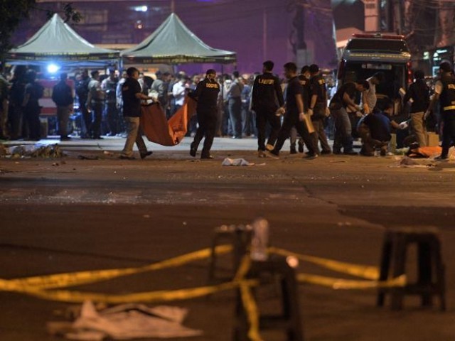 Police investigate the scene of an explosion at a bus station in Kampung Melayu, East Jakarta, Indonesia. PHOTO: REUTERS