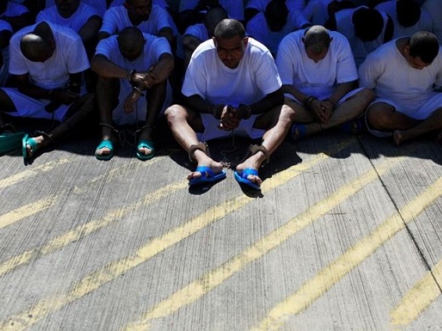 Mara Salvatrucha (MS-13) gang members wait to be escorted upon their arrival at the maximum security jail in Zacatecoluca, El Salvador. PHOTO: REUTERS