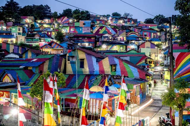 this picture shows an indonesian hamlet dubbed quot the rainbow village quot in semarang central java that has become an internet sensation and attracting hordes of visitors the village of about 200 modest homes on a hillside above a river used to be a typical low income indonesian neighbourhood that was filthy and gloomy but residents of the wonosari community in semarang decided an extreme makeover was needed and received money from the local government and several companies to carry out the project photo afp