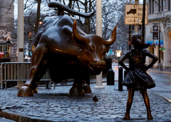 artist installs statue of a pug beside fearless girl in nyc