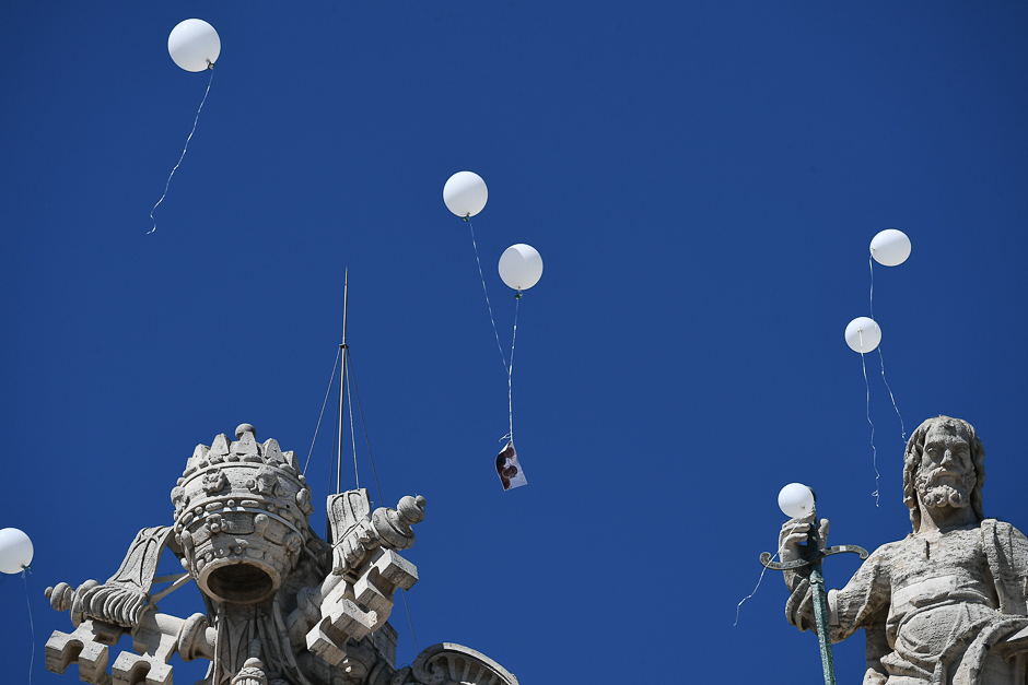 Relatives of the victims of the Hotel Rigopiano hit by an avalanche last January killing 29 people, release white balloons in the sky during a weekly general audience of Pope Francis at St Peter's square in Vatican. PHOTO: AFP